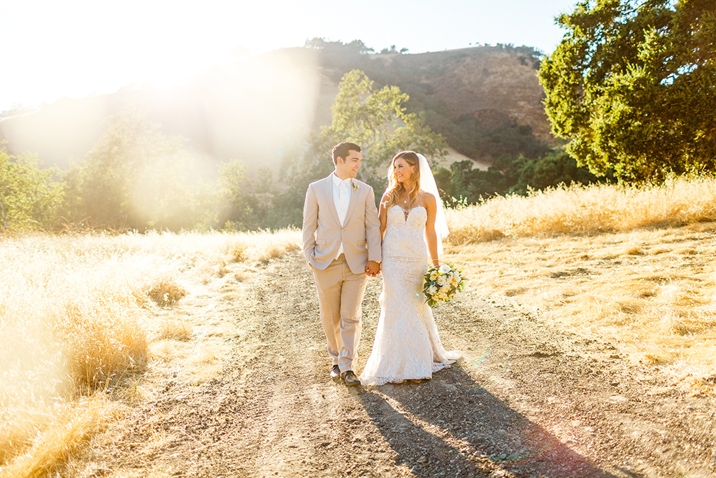 Bride and groom in the golden light at their Higuera Ranch wedding