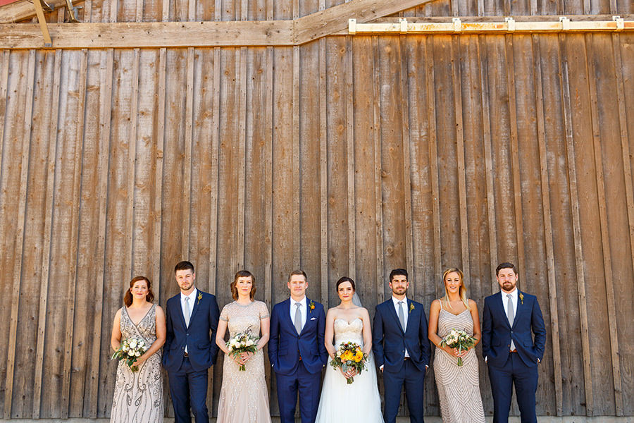 Classic wedding party in front of Thousand Hills Ranch barn