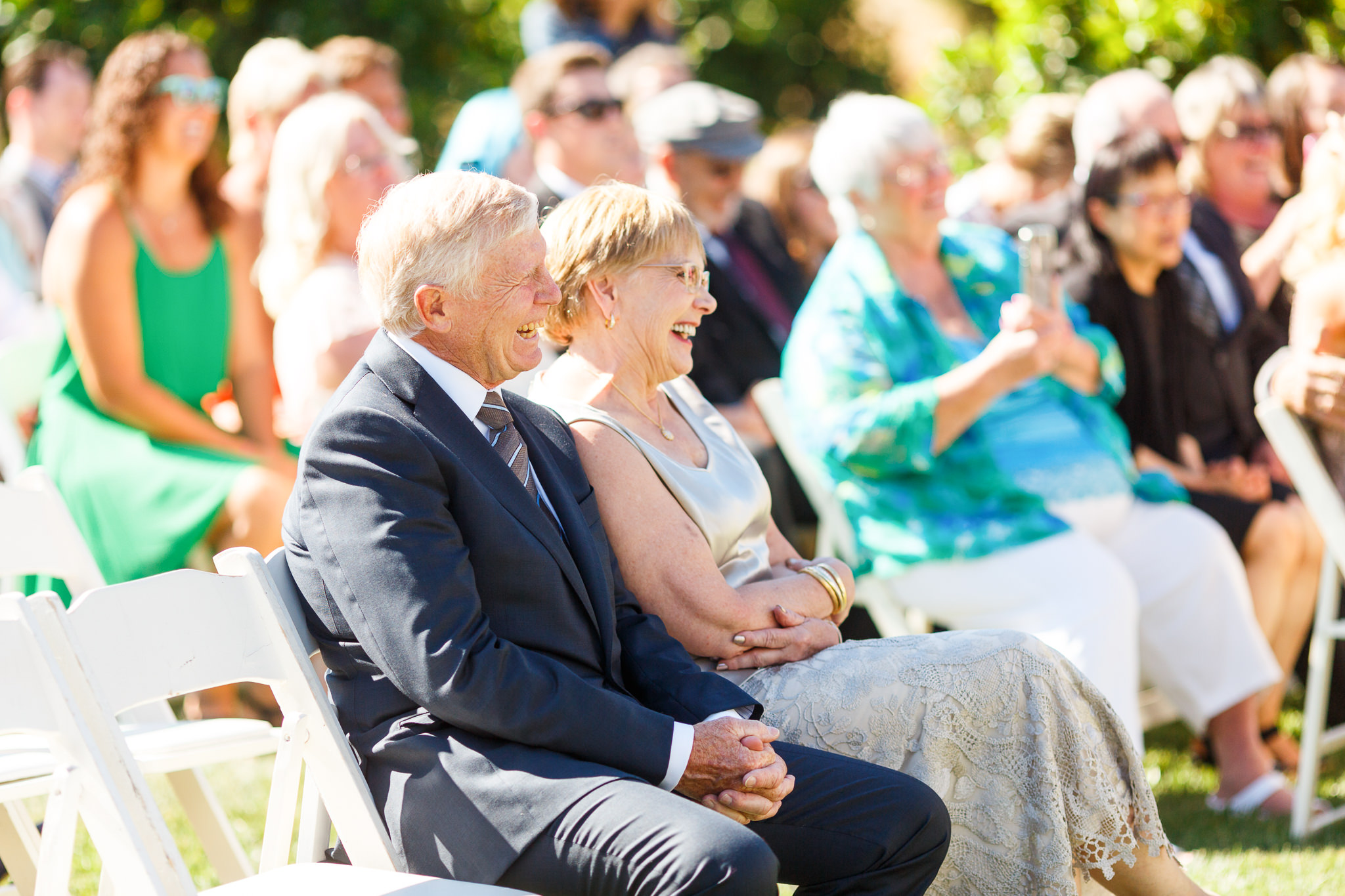 Grandparents laughing during a wedding ceremony at Dana Powers Barn