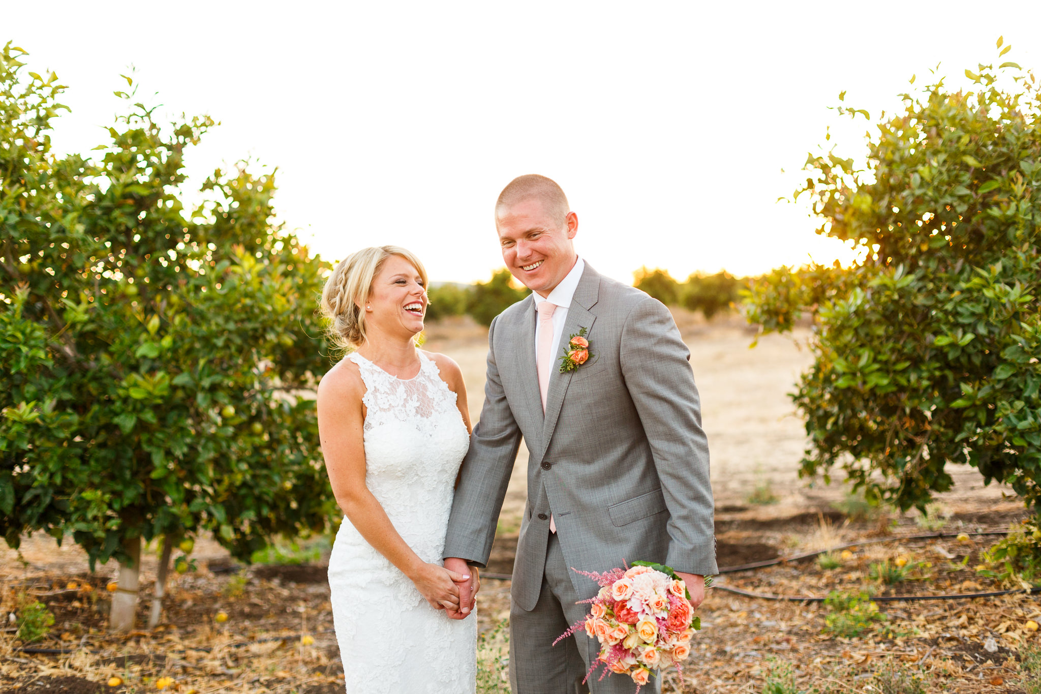 Bride and groom laughing together at sunset at Dana Powers Barn wedding