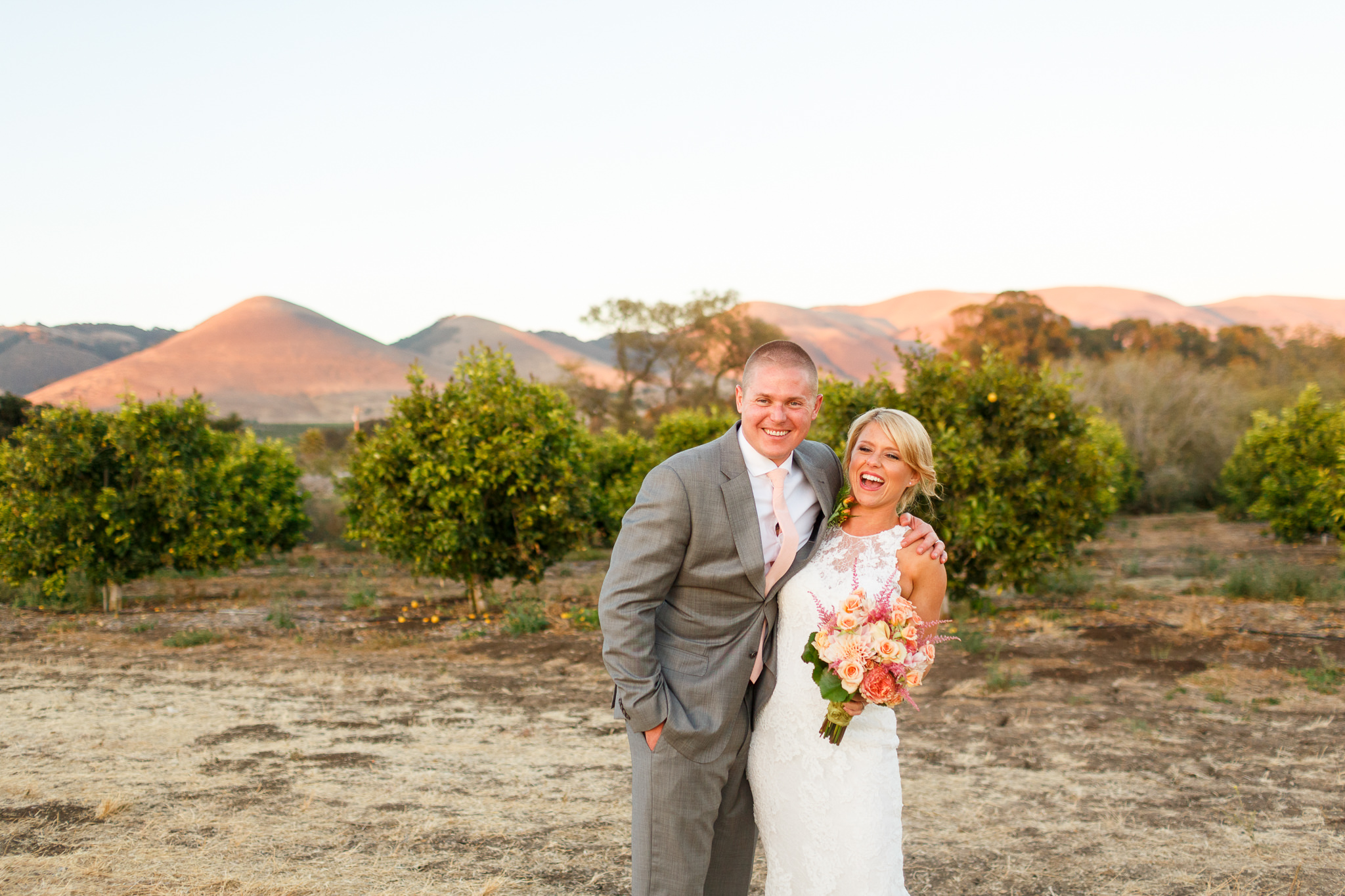 Bride and groom laughing together at sunset at Dana Powers Barn wedding