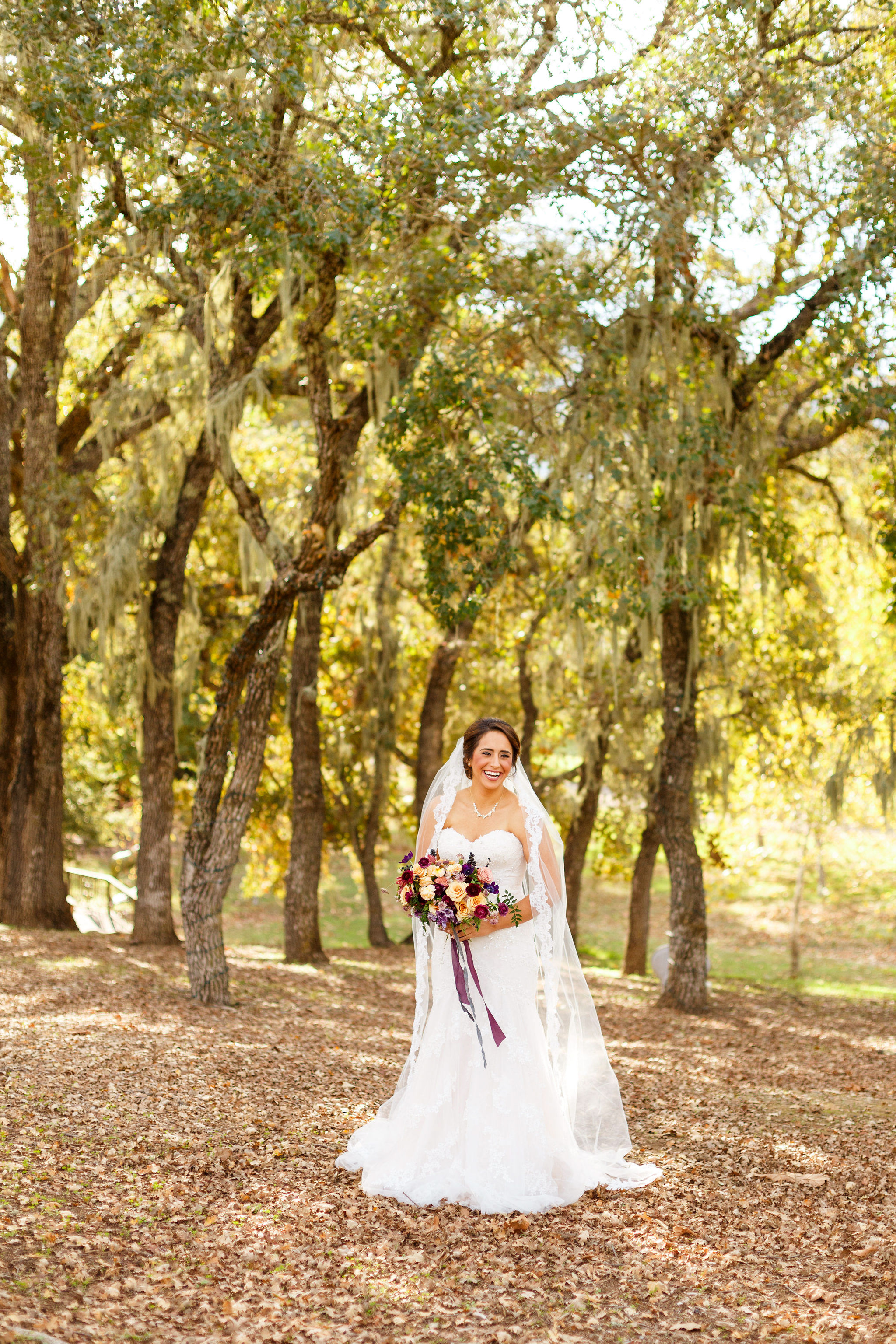 Bride Jazmin under the oak trees at Spanish Oaks Ranch wedding