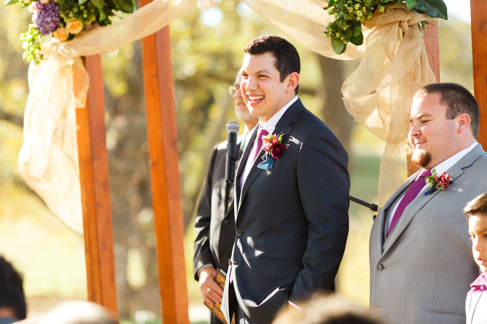 Groom laughing during the ceremony at Spanish Oaks Ranch wedding