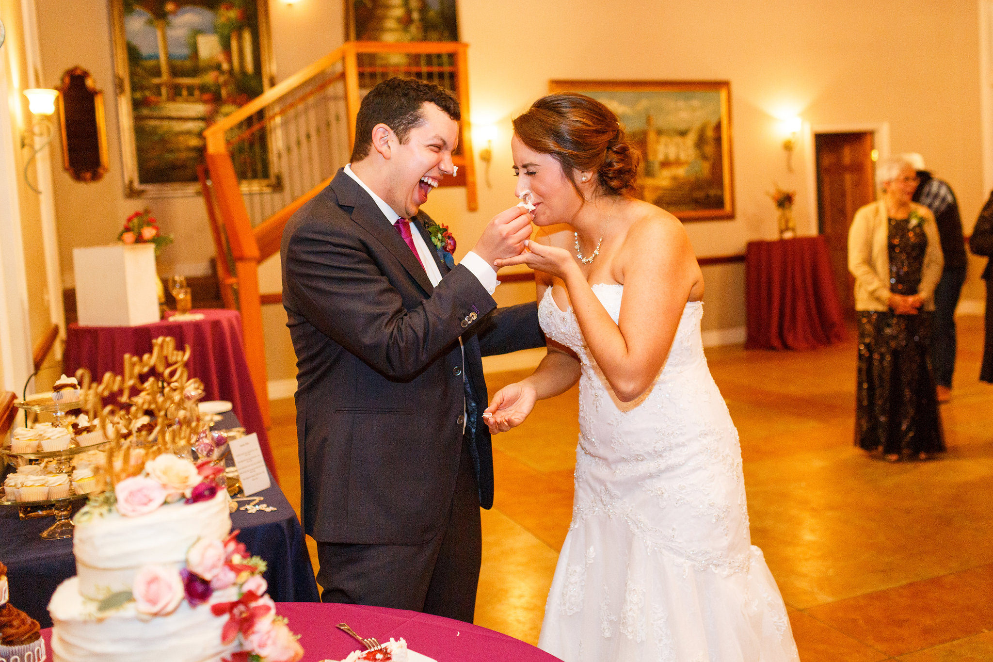 Groom shoves cake in bride's face at Spanish Oaks Ranch wedding